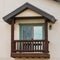 Square frame Small balcony with brown wooden railings and posts under a pitched roof