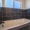 Square frame Small fitted tiled bathtub in a modern bathroom