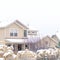 Square frame Snowy home and frosted foliage on a scenic neighborhood landscape in winter