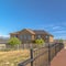 Square frame Sunny day view of bridge with brown deck and metal handrails over grassy terrain