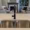 Square frame Undermount sink with double bowl and black faucet at the kitchen island of home