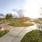 Square frame Vast park with pathways and trees on the grassy ground under the blazing sun