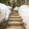 Square frame Weathered concerete outdoor steps amid snow covered slope in winter