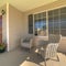 Square frame Wicker armchairs on the sunlit front porch of home with brown front door