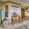 Square frame Wooden porch bench with pillows against the shiny front window