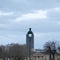 Square and funny view over a parisian street lamp with trees, Montparanasse tower and anciet buidlings