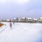 Square Glistening calm lake amid a snow covered landscape during winter in Daybreak