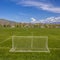 Square Goal nets and markings on a soccer field with houses and trees in the distance