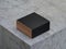 Square Golden Box Mockup in Black cover on concrete table