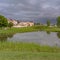 Square Grassy park with pond and pathways in the middle of lovely multi storey homes