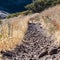 Square Gravel footpath or hiking trail through dry grass