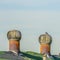 Square Green roof with metal turbine ventilator against cloudy pale blue sky