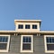 Square Grey wooden house with three upper windows