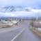 Square Highway along Utah Valley community with Wasatch Mountain and dense clouds view