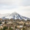 Square Hill homes with rugged snow covered mountain peak in the background