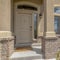 Square Home entrance with steps white front door sidelight arched windows and yard