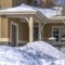 Square Home on mountainside residential community with porch and front door with wreath