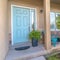 Square Home with stairs that leads to arched porch and blue front door with sidelight