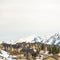 Square Homes along a paved mountain road against bright cloudy sky in winter