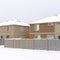 Square Homes with hip roofs and wooden fences on a neighborhood blanketed with snow