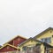 Square Homes with porches balconies and outdoor stairs under gray cloudy sky in winter