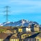 Square Homes with snow covered mountain and electricity tower in the background