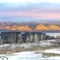 Square Homes in the snowy valley with calm lake and golden frosted mountain background