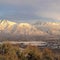 Square Houses beneath scenic Mount Timpanogos with cloudy blue sky overhead in winter