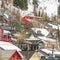 Square Houses with colorful walls built on a mountain covered with snow in winter