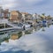 Square Huntington Beach California scenery with homes overlooking the road and canal