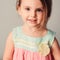 Square indoor portrait in pastel tones of cute smiling child girl