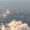 Square Industrial plant emitting thick smoke against foggy landscape in winter