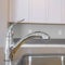 Square Kitchen interior of a new house with close up view of the shiny faucet and sink