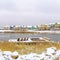 Square Lake surrounded with snow covered ground and under cloudy sky in winter