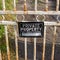 Square Locked rusty old gate with private property sign and view of lake and mountain