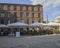 Square in Lodz city center with restaurants and old red brick fa