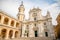 Square of Loreto, Basilica della Santa Casa in sunny day, portico to the side, people in the square in Loreto, Ancona