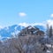 Square Magnificent Wasatch Mountains in winter with lovely homes and abundant trees