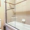 Square Master bath in luxury home with large glass shower bright and clean