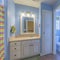 Square Master bathroom with light blue interior and two vanity sinks