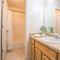 Square Modern bathroom interior with white wall and view of bathtub toilet and vanity