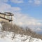 Square Mountainside home overlooking the valley and Wasatch Mountains under cloudy sky