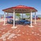 Square Octagon shaped picnic pavilion with view of colorful playground and scenic lake