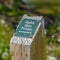 Square Ogden River Parkway sign on a rustic wooden post in Utah