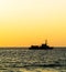 Square orange vivid ocean horizon with ship silhouette