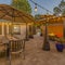 Square Outdoor dining and seating area on the cozy stone patio of a home