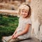 Square outdoor portrait in pastel tones of cute smiling child girl