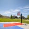 Square Outdoor public basketball court with home mountain and blue sky background