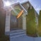 Square Pathway and stairs leading to the arched entrance and front door of a home