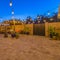 Square Patio dining and seating area inside the stone fence and wooden gate of a home